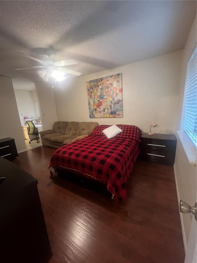 bedroom with a textured ceiling, baseboards, ceiling fan, and wood finished floors
