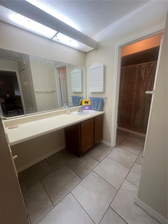 bathroom featuring vanity, a textured ceiling, a shower with shower curtain, and tile patterned flooring