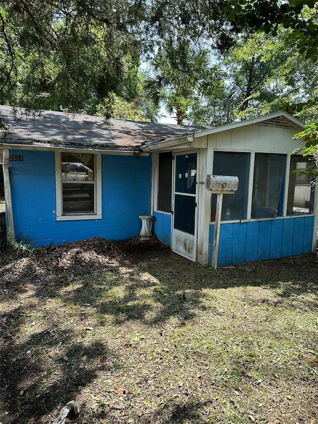 view of side of home featuring a sunroom