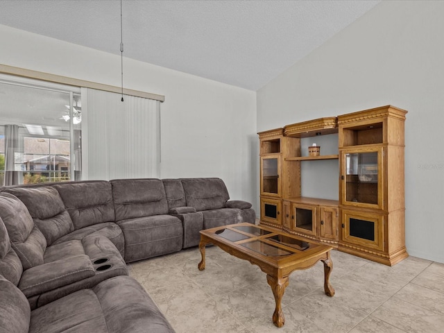 living room featuring a textured ceiling and high vaulted ceiling