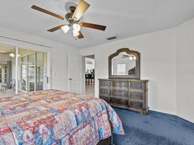 carpeted bedroom featuring a textured ceiling and ceiling fan