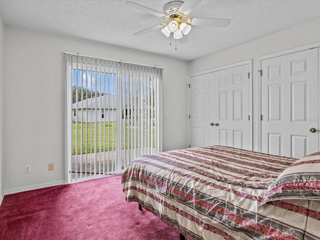 bedroom with two closets, carpet, ceiling fan, access to outside, and a textured ceiling