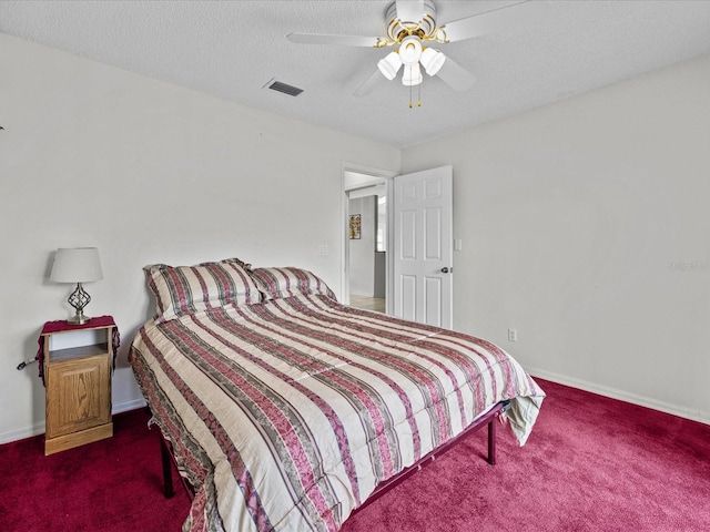 bedroom featuring ceiling fan, a textured ceiling, and dark carpet