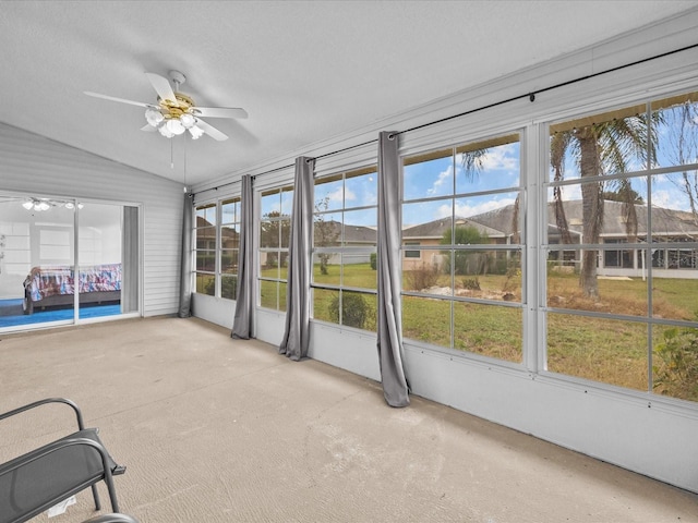 unfurnished sunroom featuring ceiling fan and lofted ceiling