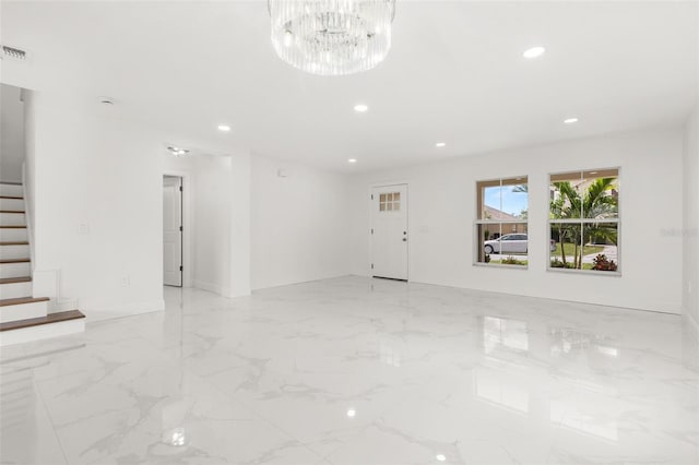 spare room featuring a chandelier