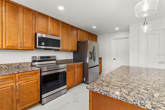 kitchen featuring stone counters, hanging light fixtures, and stainless steel appliances