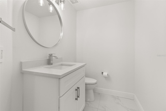 bathroom with toilet and vanity