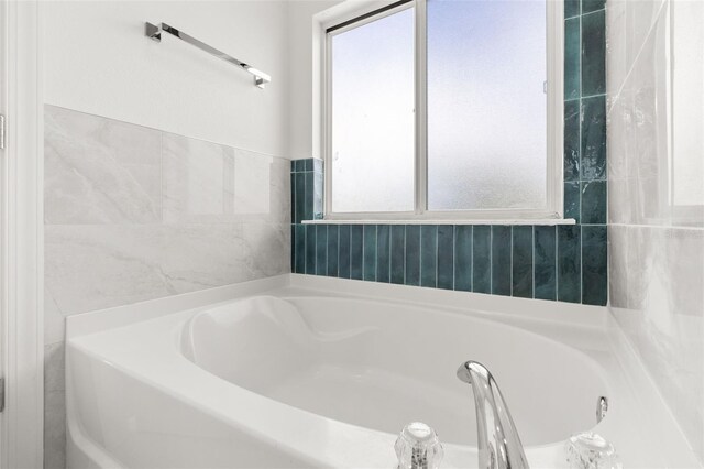 bathroom with a tub to relax in