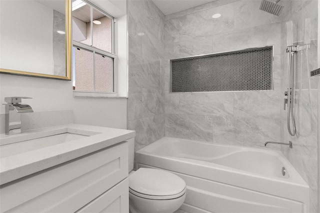 full bathroom featuring vanity, toilet, and tiled shower / bath combo