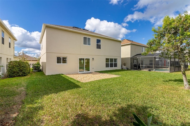 back of property featuring a yard and glass enclosure