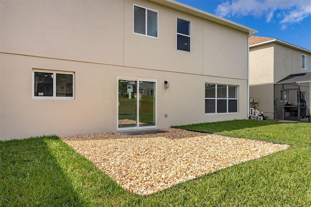 rear view of property featuring a yard