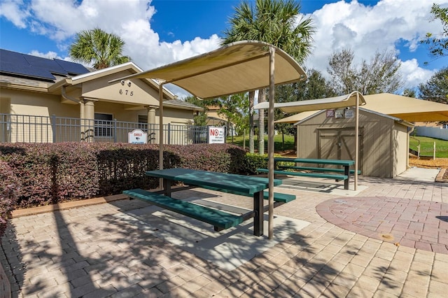 view of patio featuring a storage unit