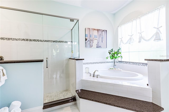 bathroom featuring separate shower and tub