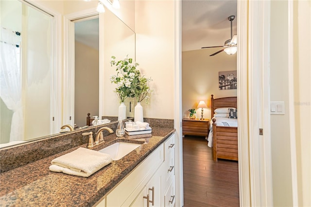 bathroom with vanity, hardwood / wood-style flooring, and ceiling fan