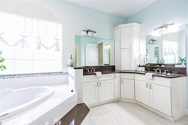 bathroom featuring vanity and tiled bath