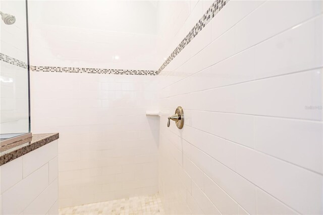 bathroom with a tile shower