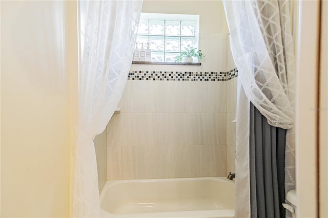 bathroom featuring shower / bath combo with shower curtain