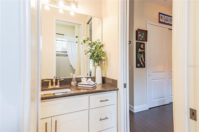 bathroom with vanity and hardwood / wood-style floors