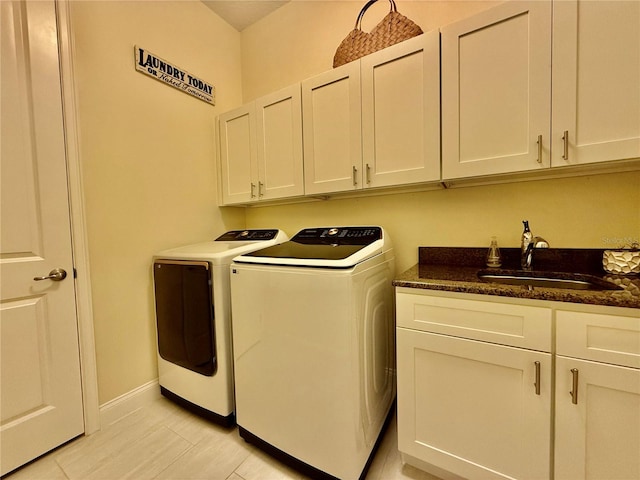 washroom featuring cabinets, washer and dryer, and sink