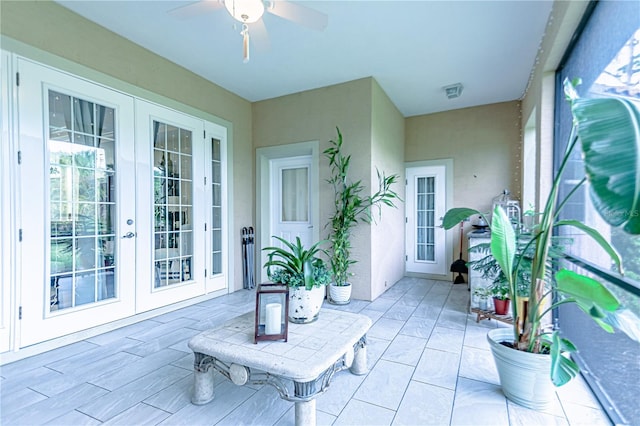 sunroom / solarium with french doors and ceiling fan