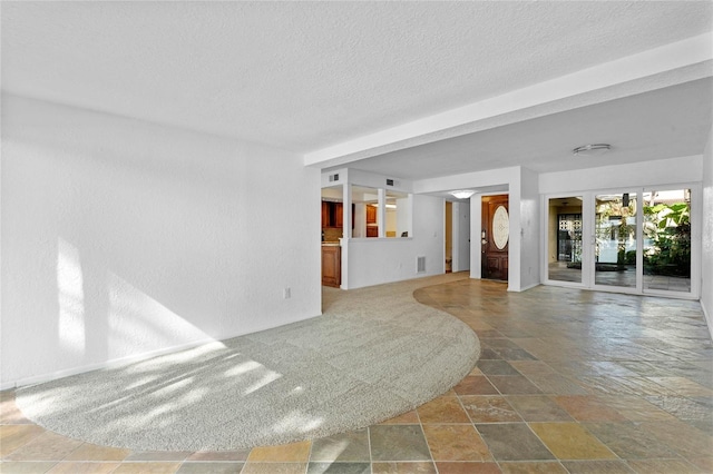 unfurnished living room with a textured ceiling