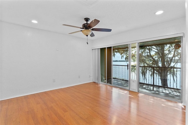 spare room featuring light hardwood / wood-style flooring and ceiling fan