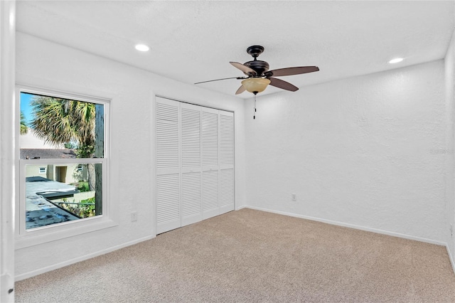 unfurnished bedroom featuring a closet, ceiling fan, and carpet floors