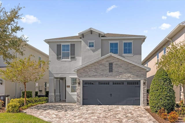 365 Southfield St, Kissimmee, FL 34747 - traditional-style home featuring stone siding, stucco siding, decorative driveway, and a garage