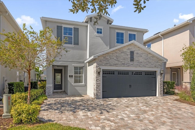 365 Southfield St, Kissimmee, FL 34747 - traditional-style house with stucco siding, stone siding, driveway, and a garage