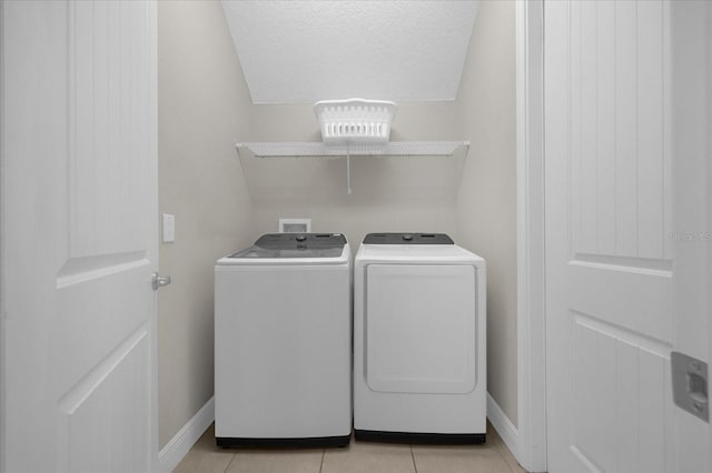 365 Southfield St, Kissimmee, FL 34747 - laundry room featuring washer and dryer, light tile patterned floors, and a textured ceiling