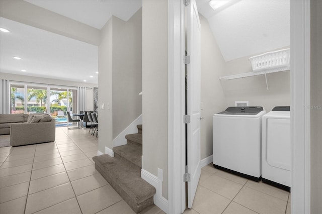 washroom with washing machine and dryer and light tile patterned floors