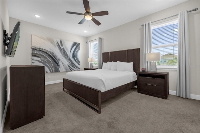 bedroom with ceiling fan and light carpet