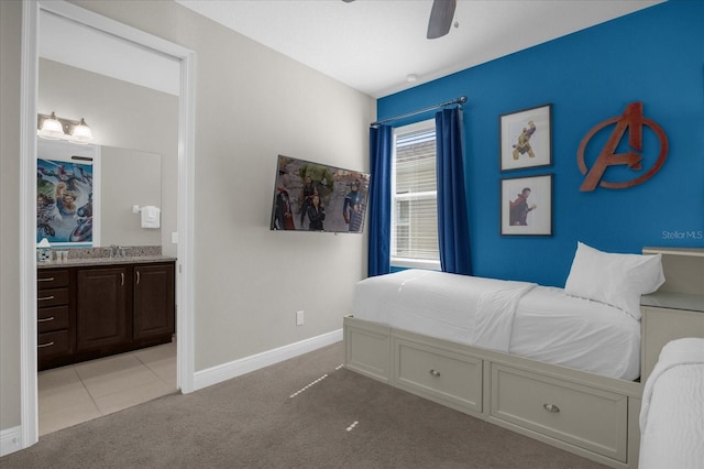 bedroom with light carpet, connected bathroom, ceiling fan, and sink