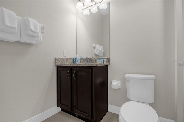 bathroom with tile patterned floors, vanity, and toilet