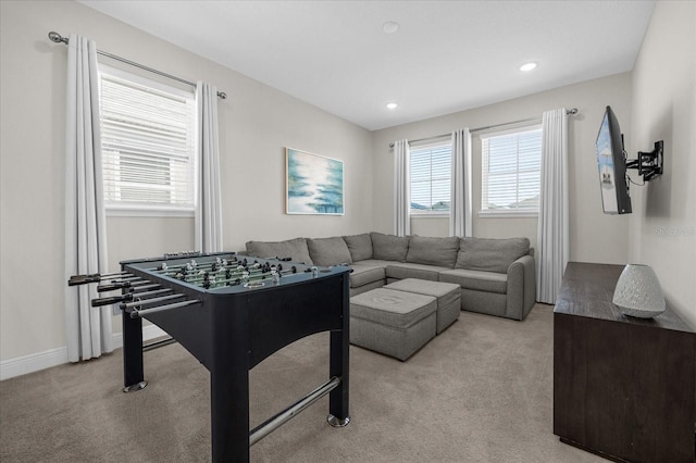 recreation room featuring plenty of natural light and light colored carpet