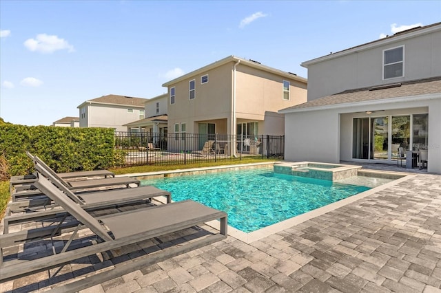 view of pool with an in ground hot tub and a patio