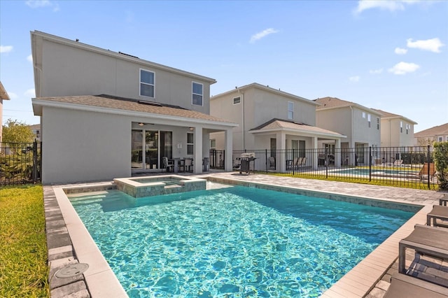 view of pool featuring a patio area, an in ground hot tub, and grilling area