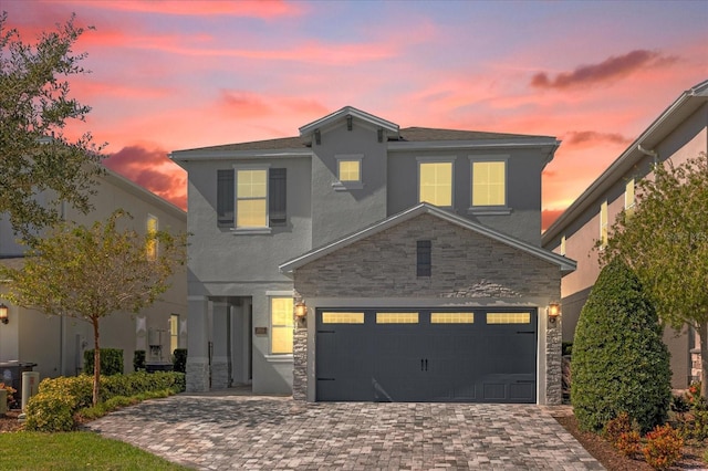 365 Southfield St, Kissimmee, FL 34747 - traditional-style home with stone siding, decorative driveway, stucco siding, and an attached garage