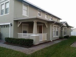 exterior space with a yard, a porch, and a garage