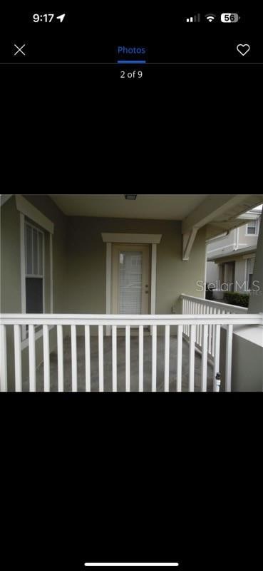 view of exterior entry with a balcony