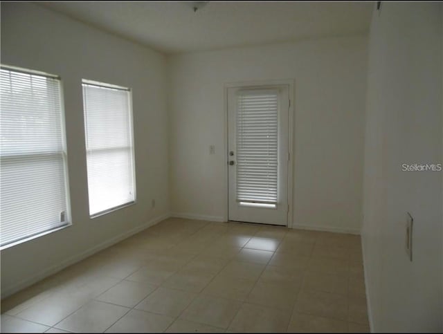 spare room featuring light tile patterned floors