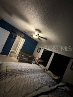 unfurnished bedroom featuring a textured ceiling and ceiling fan