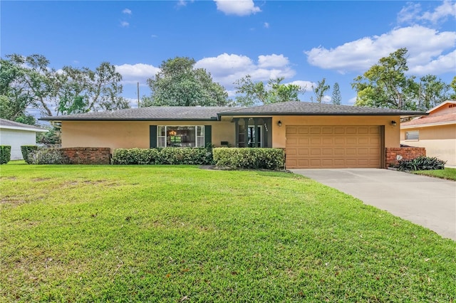 single story home featuring a garage and a front yard