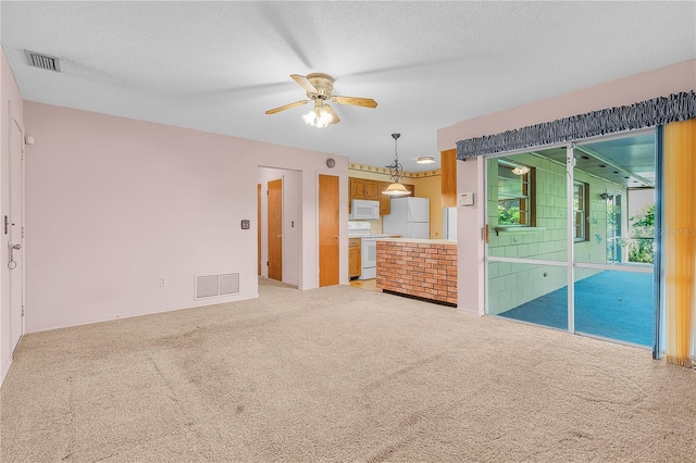 interior space featuring carpet floors, a textured ceiling, and ceiling fan