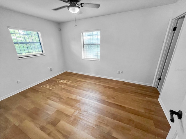 spare room with hardwood / wood-style flooring and ceiling fan