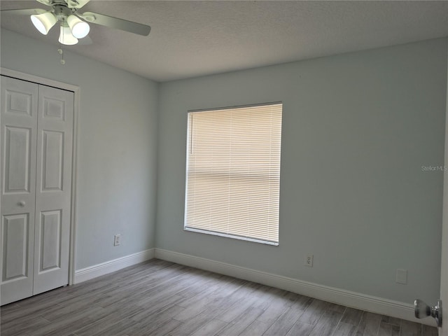 unfurnished bedroom featuring a closet, ceiling fan, a textured ceiling, and light hardwood / wood-style floors