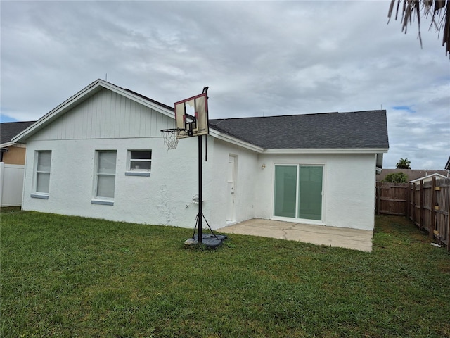 back of property featuring a yard and a patio area