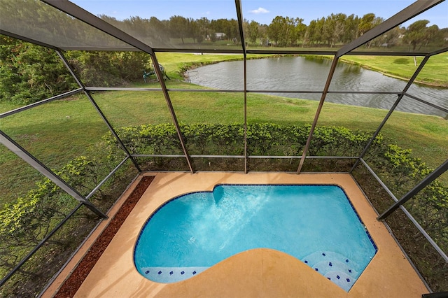 view of swimming pool with a yard and a water view