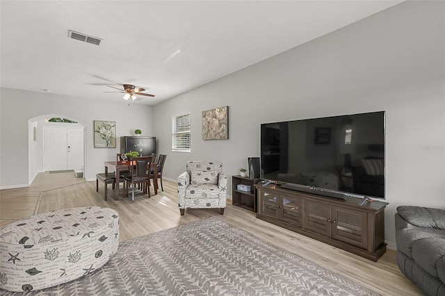 living room with ceiling fan and light hardwood / wood-style floors