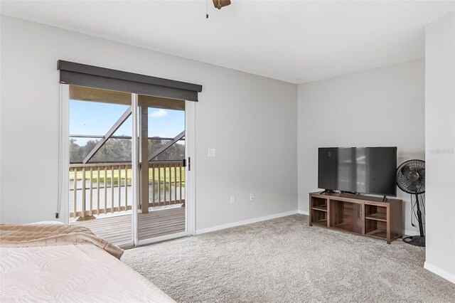 carpeted bedroom featuring ceiling fan and access to exterior